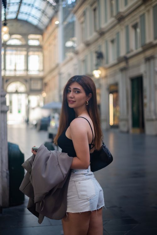 Free Stylish woman in Genoa's historic Galleria Mazzini, Italy, showcasing urban fashion. Stock Photo