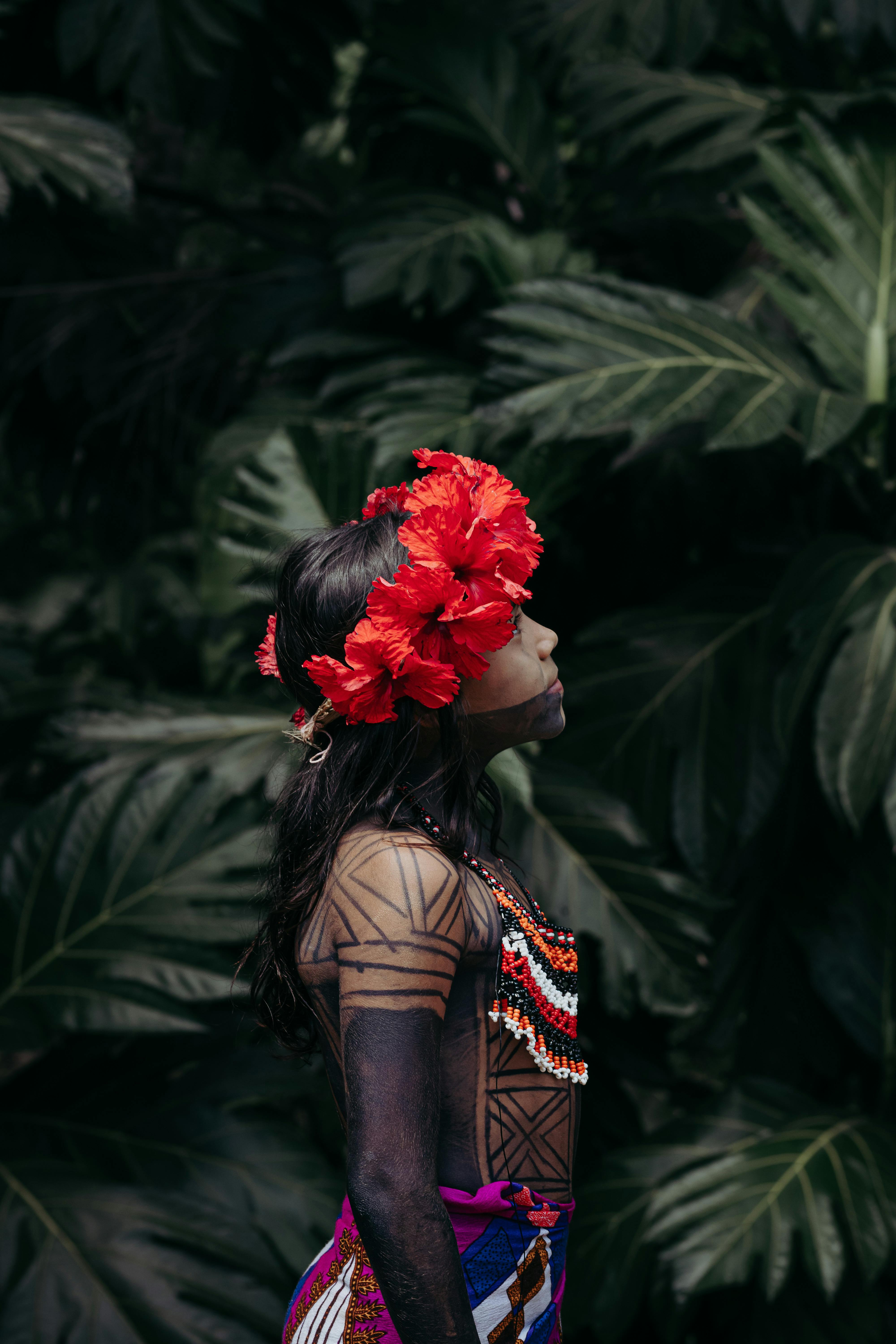 person with flowers wreath and tattoos