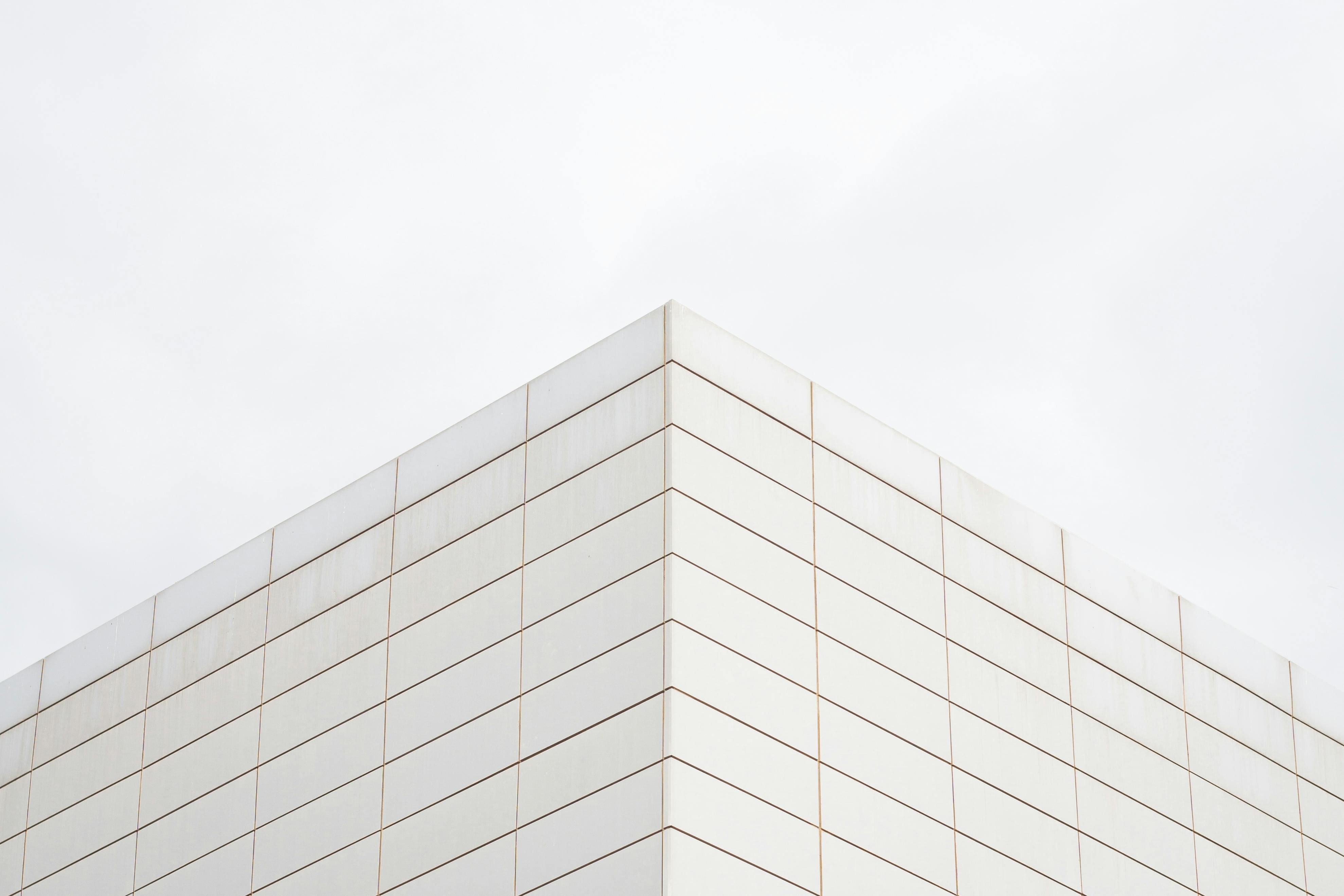 A minimalist architectural photo of a modern building corner with clean symmetry.