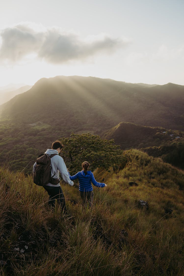 Man And Woman Hiking On Hills