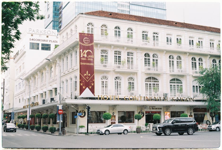 Classic architecture of Hotel Continental Saigon on a bustling Ho Chi Minh street.