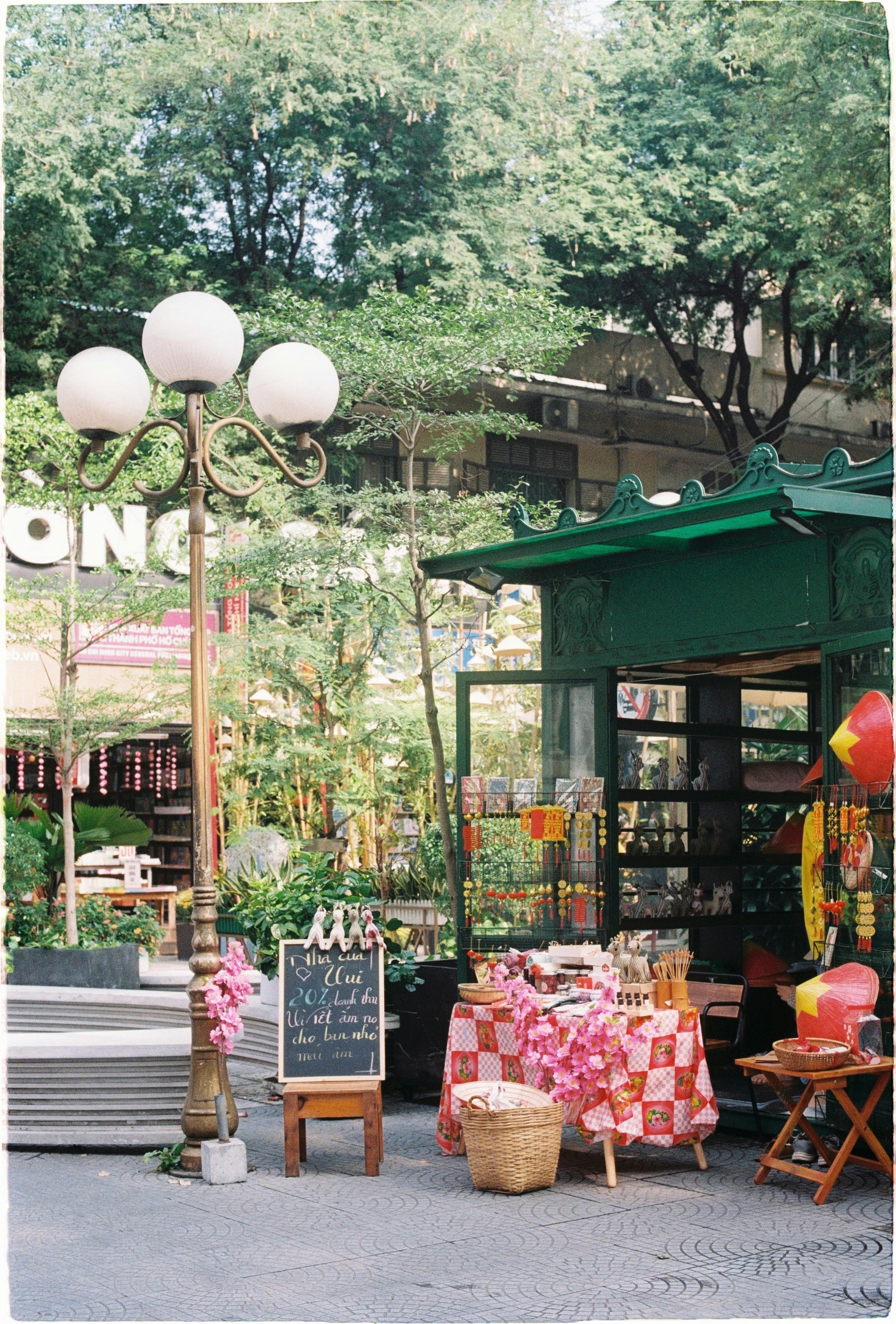 Rustic street-side café and souvenir shop with vibrant decorations and outdoor seating.