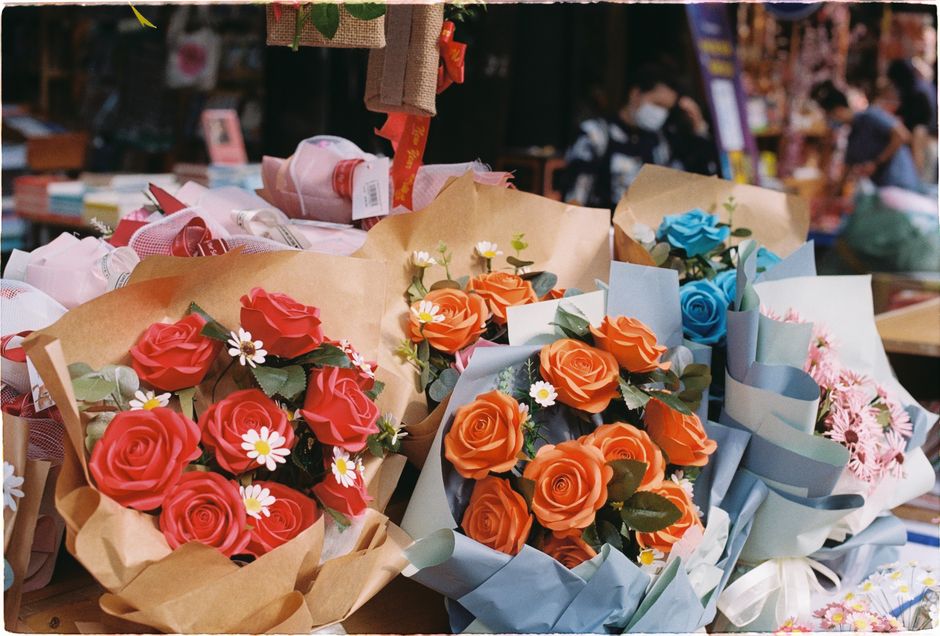 Vibrant flower bouquets on display at an outdoor street market.
