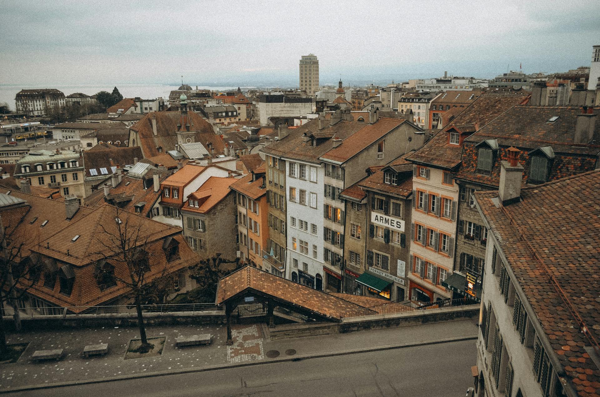 Charming view of historic European town with old rooftops and townhouses under overcast sky.