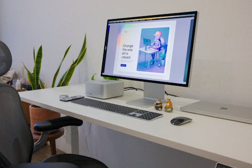 Mac Studio Computer and MacBook Pro Laptop on a White Desk
