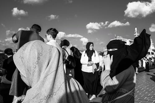 People Wearing Headscarves on a Street in Black and White 
