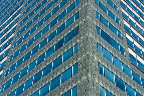 Free Detailed view of a modern skyscraper facade with reflective blue glass windows. Stock Photo