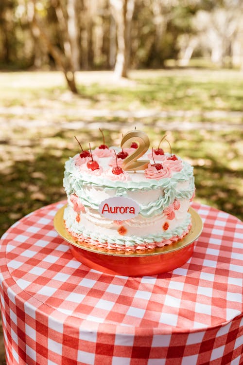 A Birthday Cake on a Table Outside 