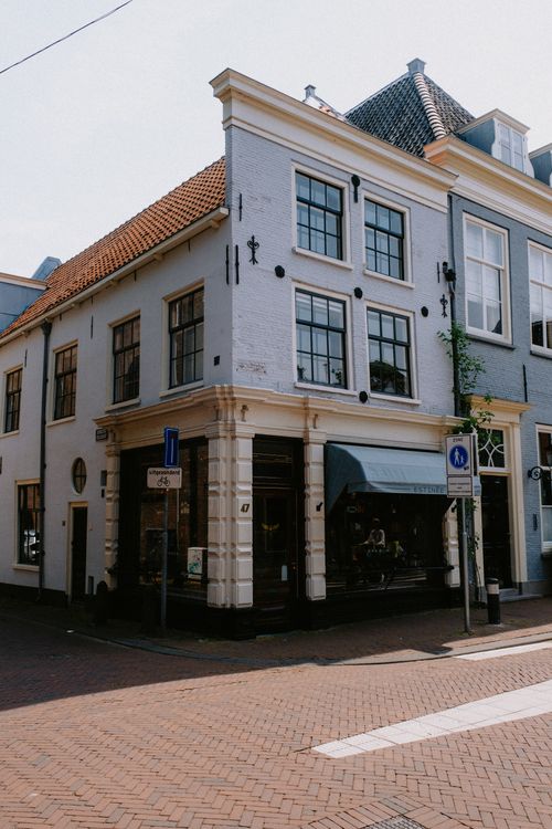 Free Charming European street corner with historic buildings and classic facade details. Stock Photo
