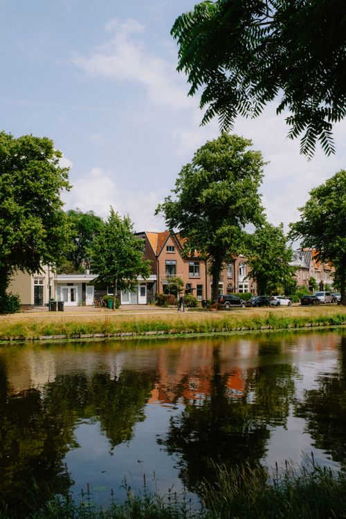 Free Picturesque view of historic houses and tranquil canal in Haarlem, Netherlands. Stock Photo