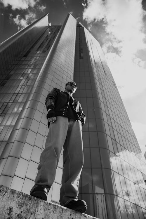 Man Standing near Glass Modern Building 