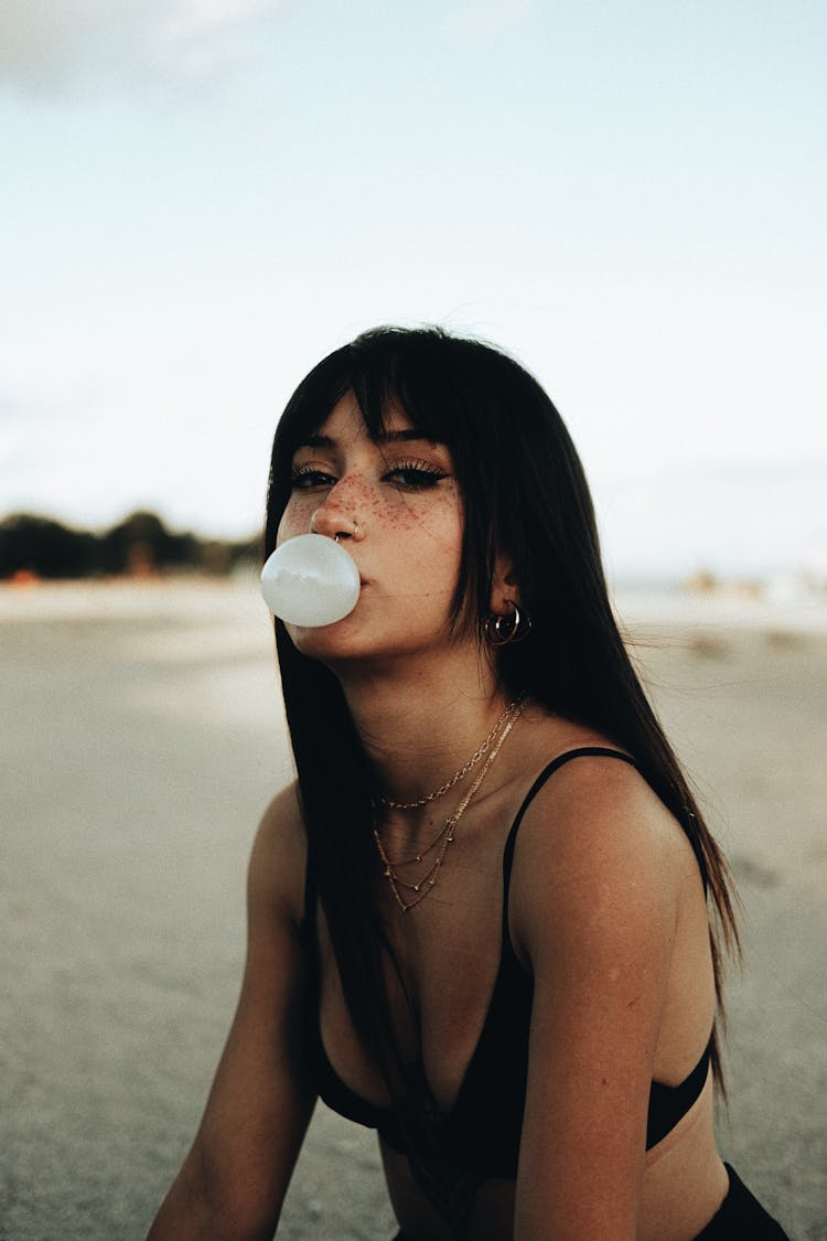 Young Woman Blowing A Bubblegum Balloon 