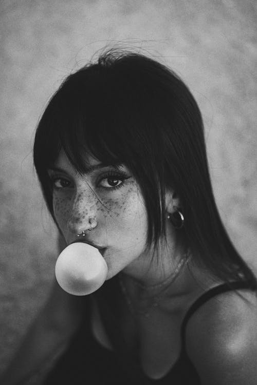 Young Woman Blowing Gum Bubble