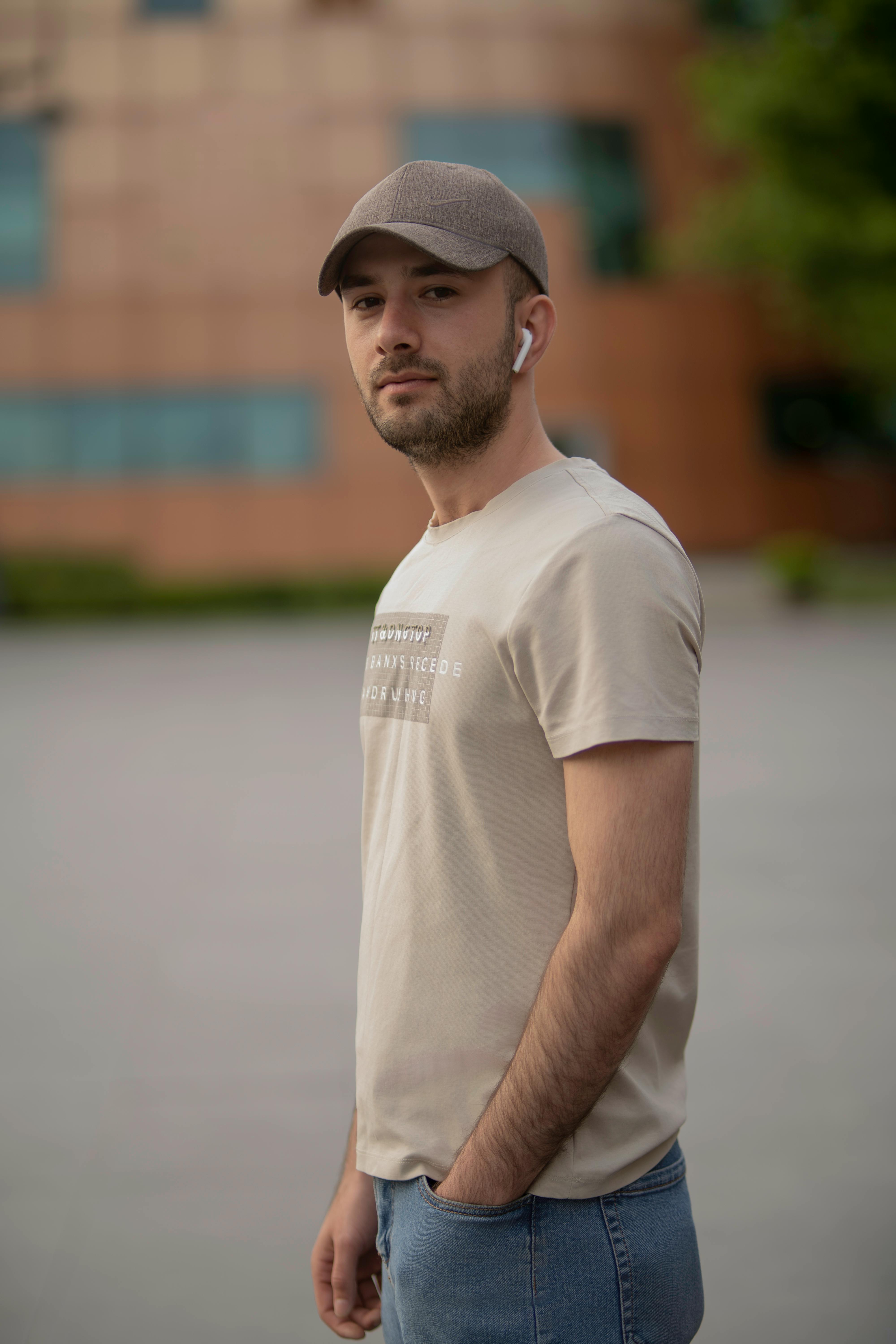 Photo of Man in Gray Shirt, Black Nike Jacket, and Red New York