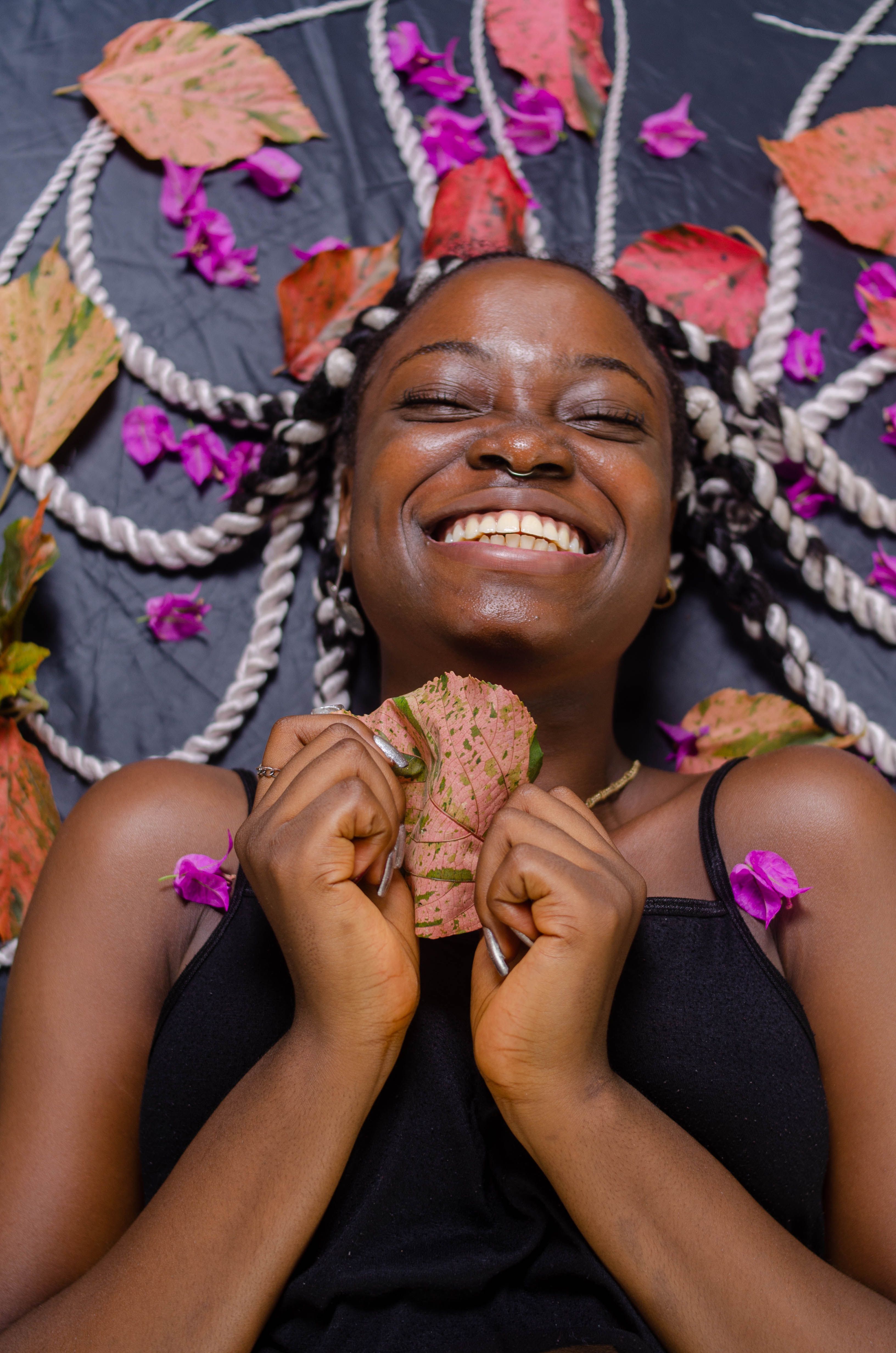Smiling Woman with Leaf · Free Stock Photo