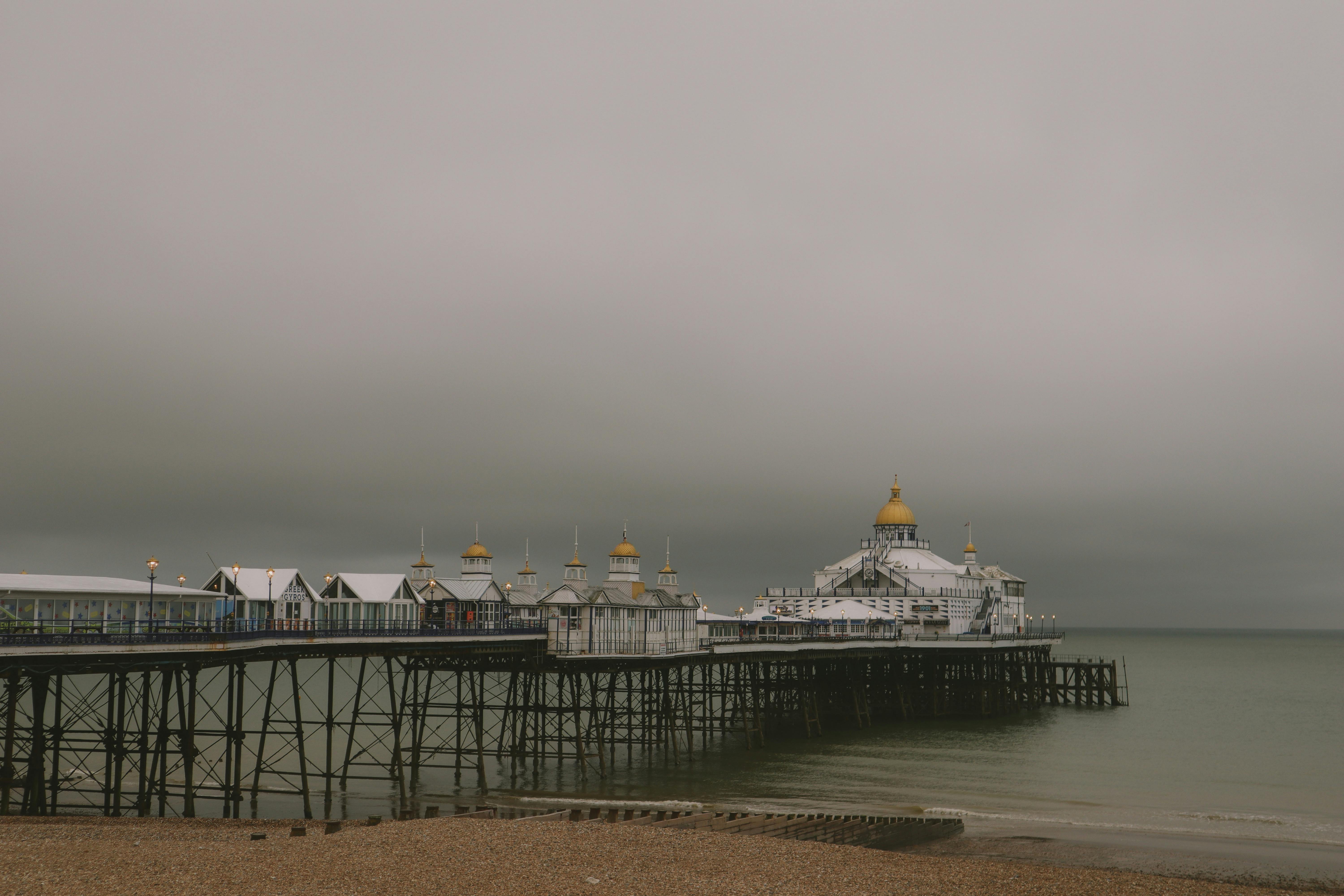 Scenic view of Eastbourne Pier in England on a misty day, capturing its elegance.