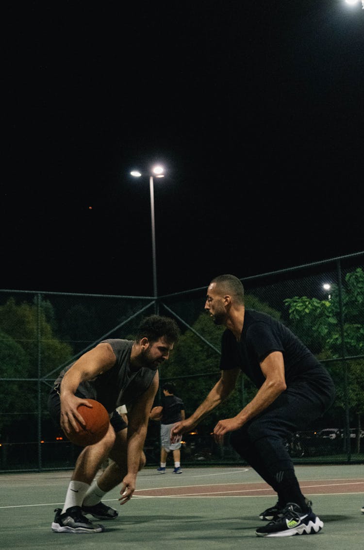 Men Playing Basketball At Night