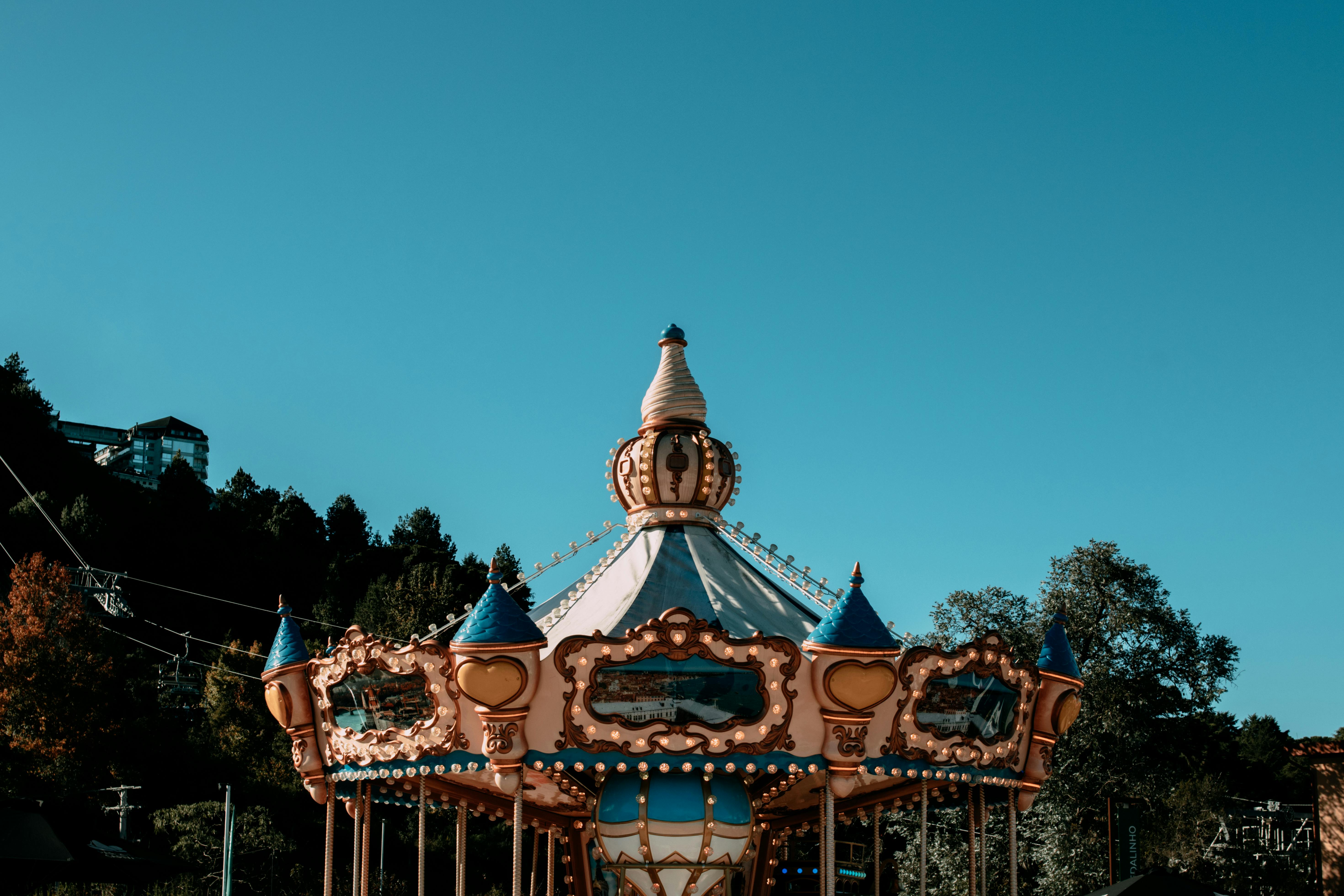 Captivating carousel ride under a clear blue sky in Campos do Jordão, Brazil.