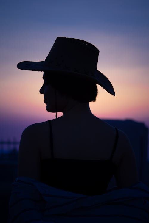Silhouette of a Woman Wearing a Hat 
