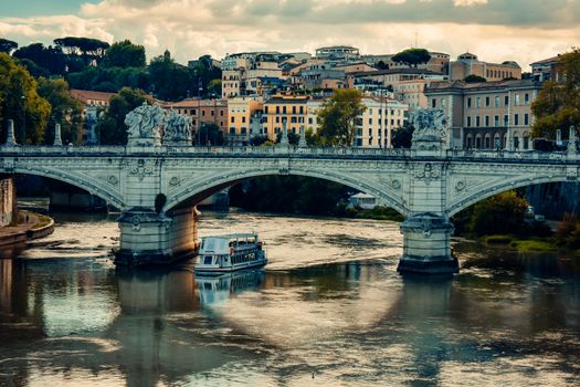 A serene view of the Ponte Vittorio Emanuele II bridge over the Tiber River in Rome, Italy, during the day.
