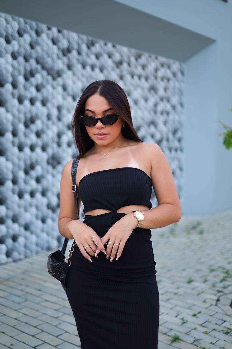 Standing Woman In Black Strapless Dress