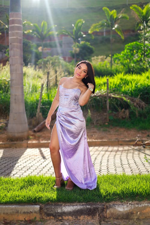 Young Woman in a Silk Dress Posing Outside 