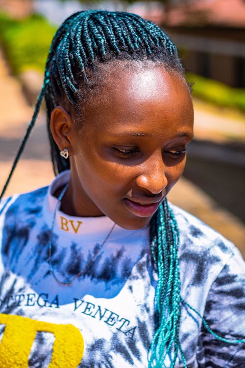 Free Beautiful Young Girl with Blue Dreadlocks Looking Down Stock Photo