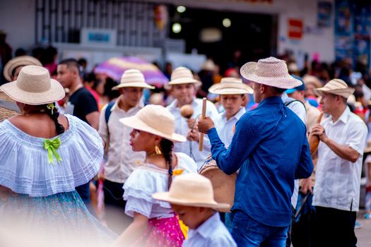 Panamanian festival showcasing colorful traditional attire and music in an urban setting.