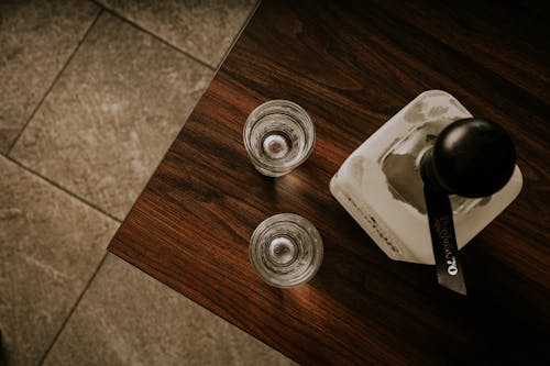 Glasses and Flask of Perfume on Table