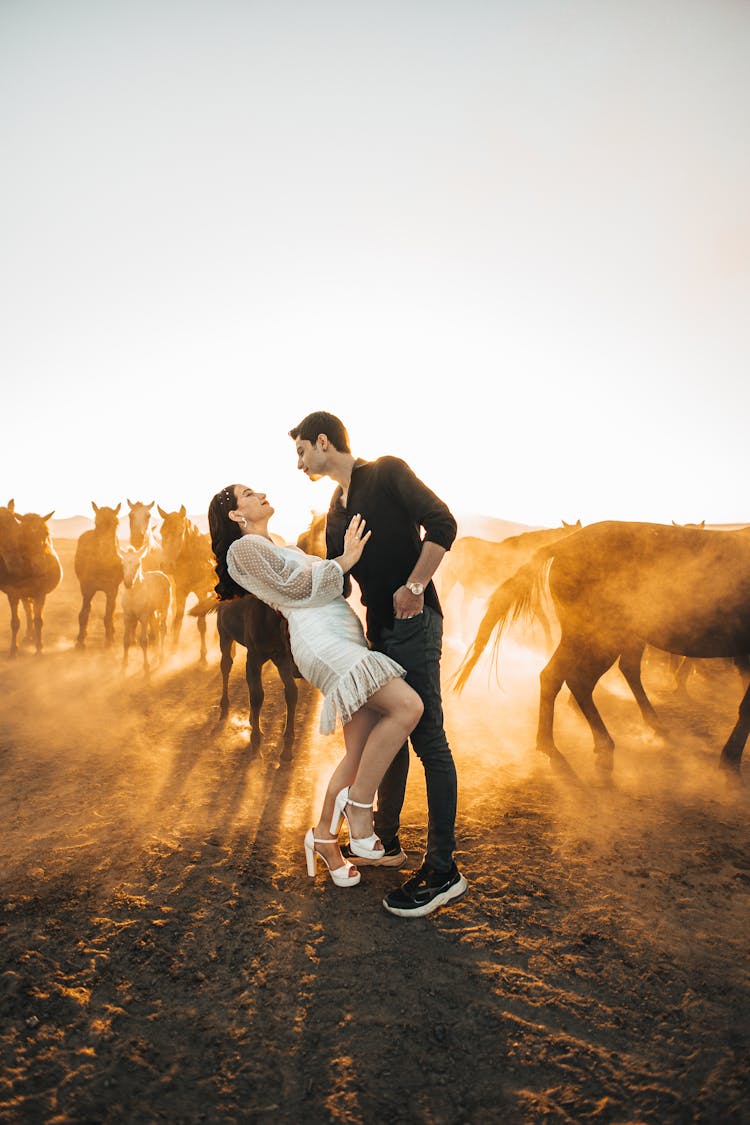 Couple In A Field At Sunset 