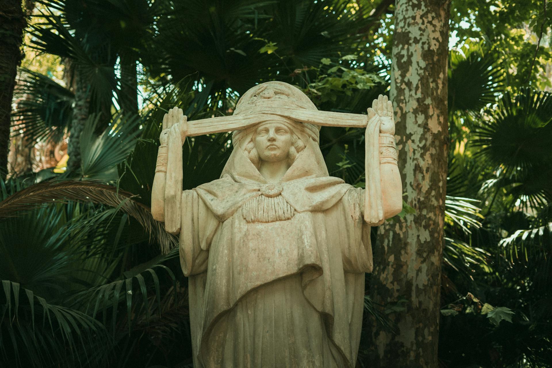 Historic statue of a goddess in Alger Centre's lush park, evoking spirituality.