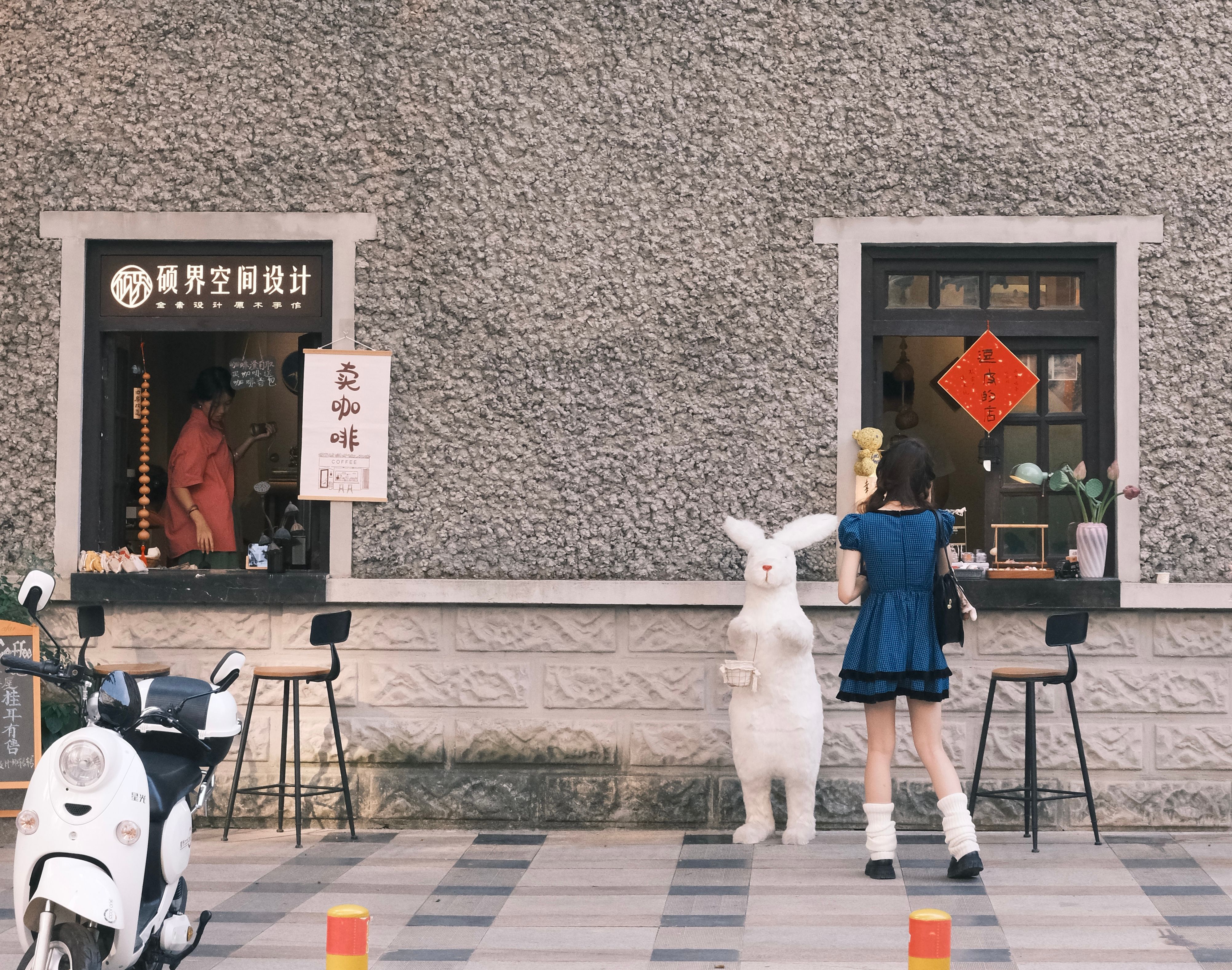 Girl Standing near Traditional Asian Shop in Building · Free Stock Photo