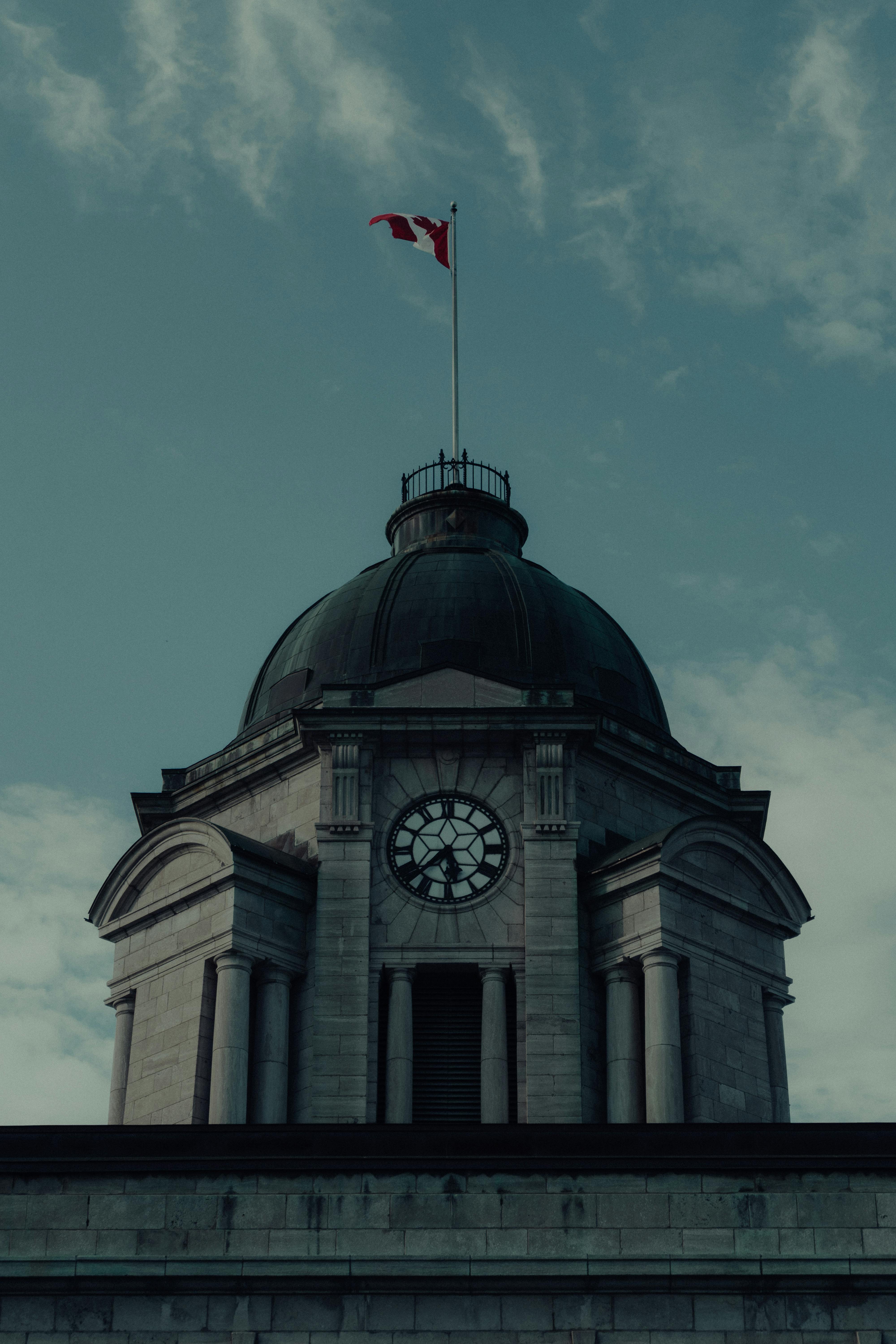 a clock tower with a flag flying above it