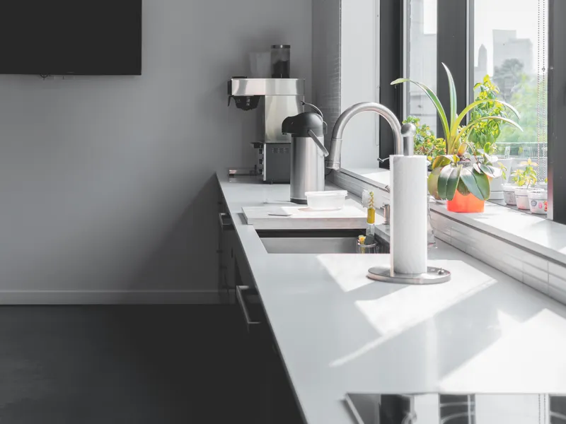 Modern kitchen with a sunlit countertop and large windows Modern kitchen with a sunlit countertop and large windows