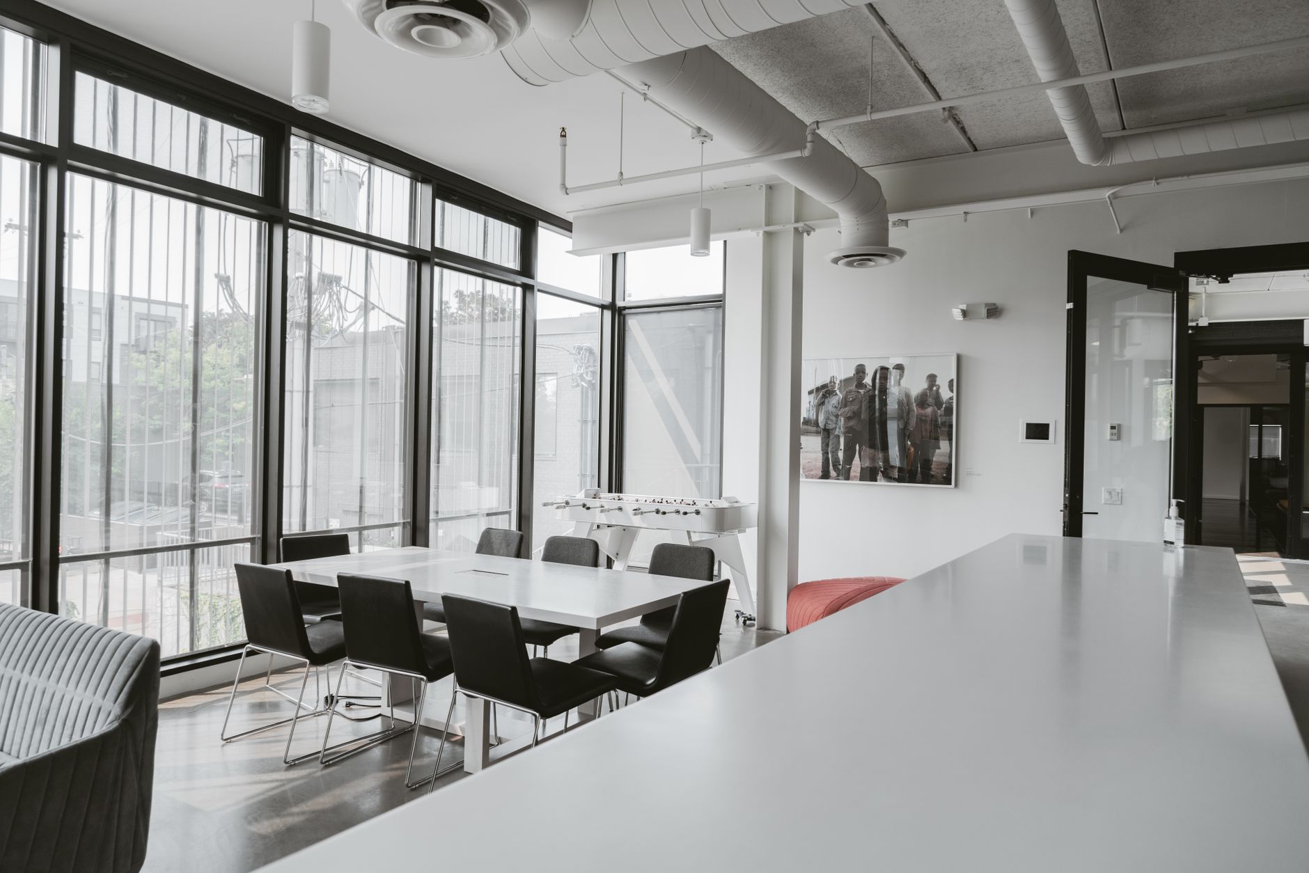 Sunlit meeting room with a long table and designer chairs