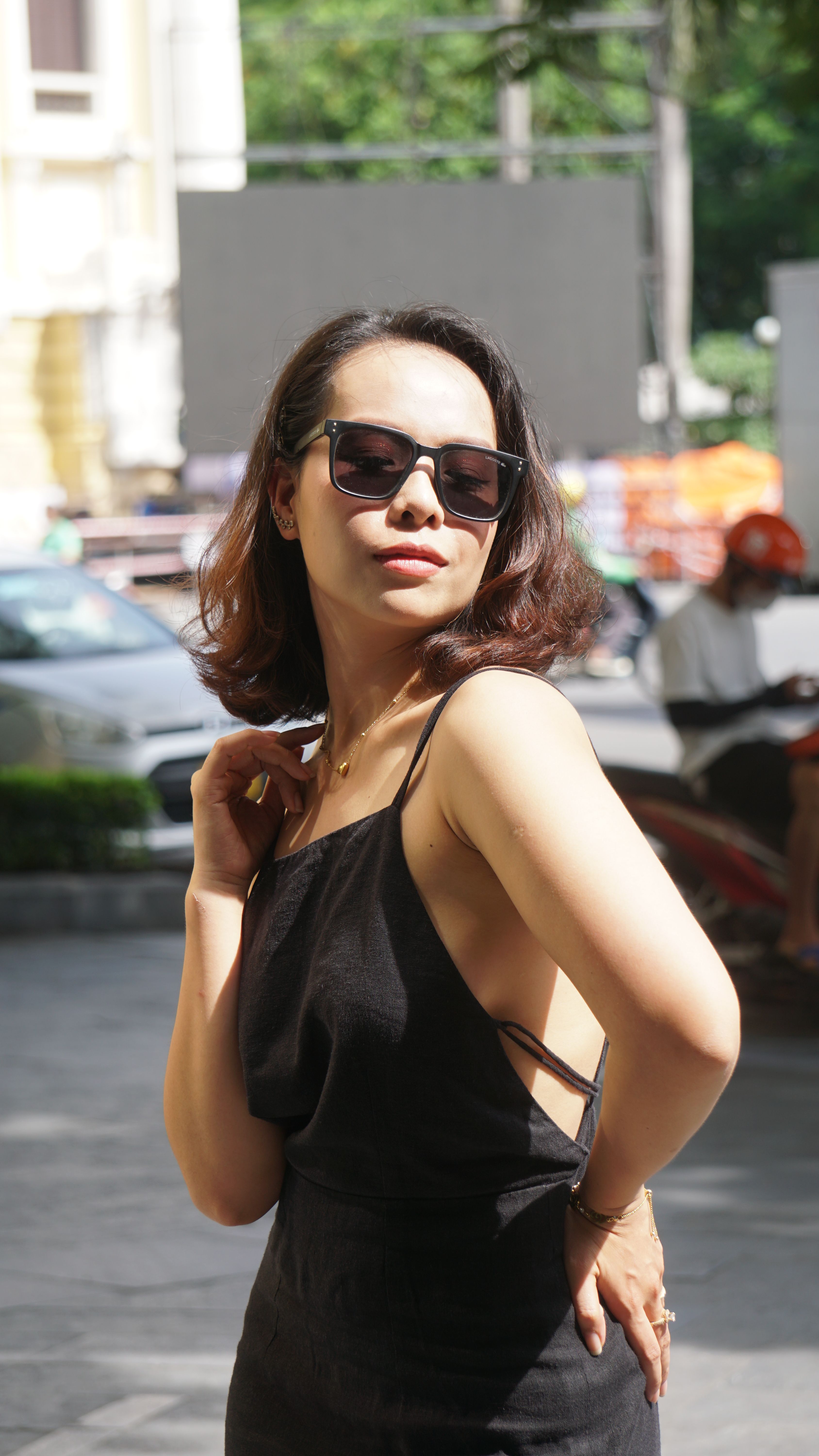 Beautiful Woman in Black Dress Posing in Sunlight · Free Stock Photo