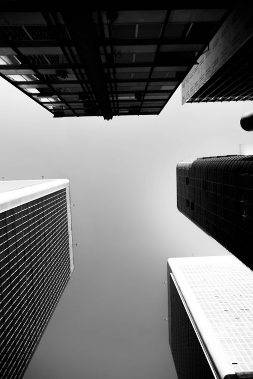 Free Dramatic black and white perspective of urban skyscrapers against the sky. Stock Photo