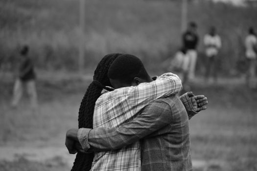 Two Embracing People in Black and White