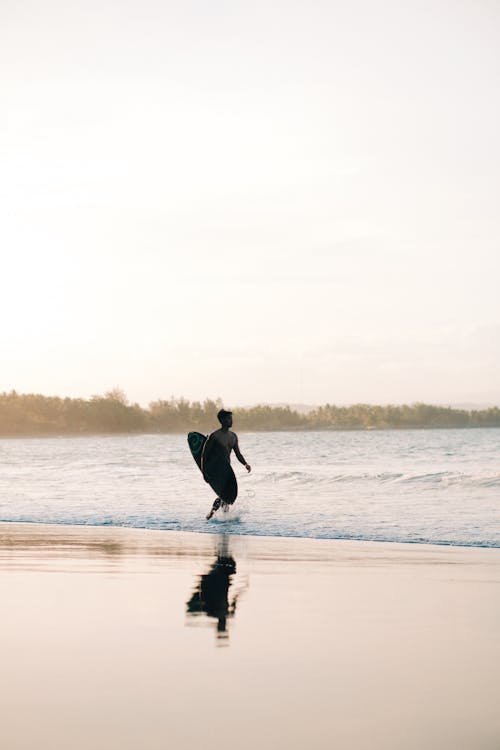 Woman Running through the Beach