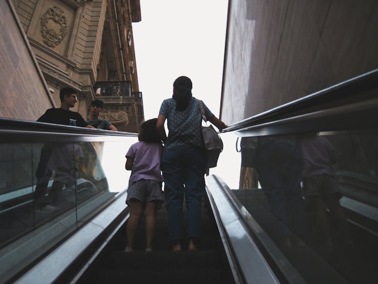 Mother With Daughter On Escalator