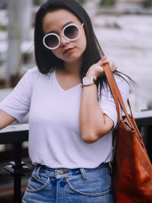 Woman in Sunglasses Holding Bag