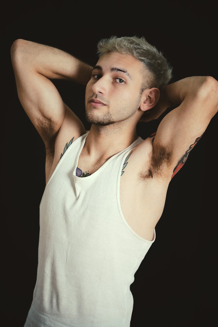 Young Blonde Man Posing In A White Top