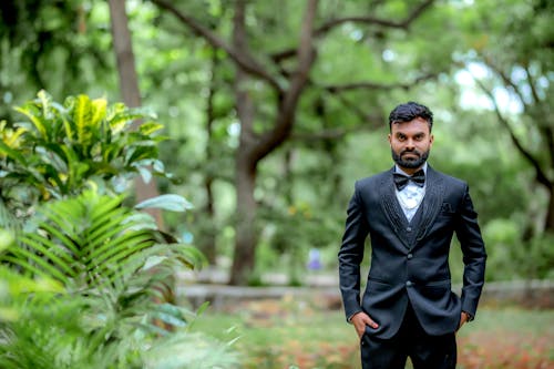 Elegant Man in a Suit Standing in a Park 