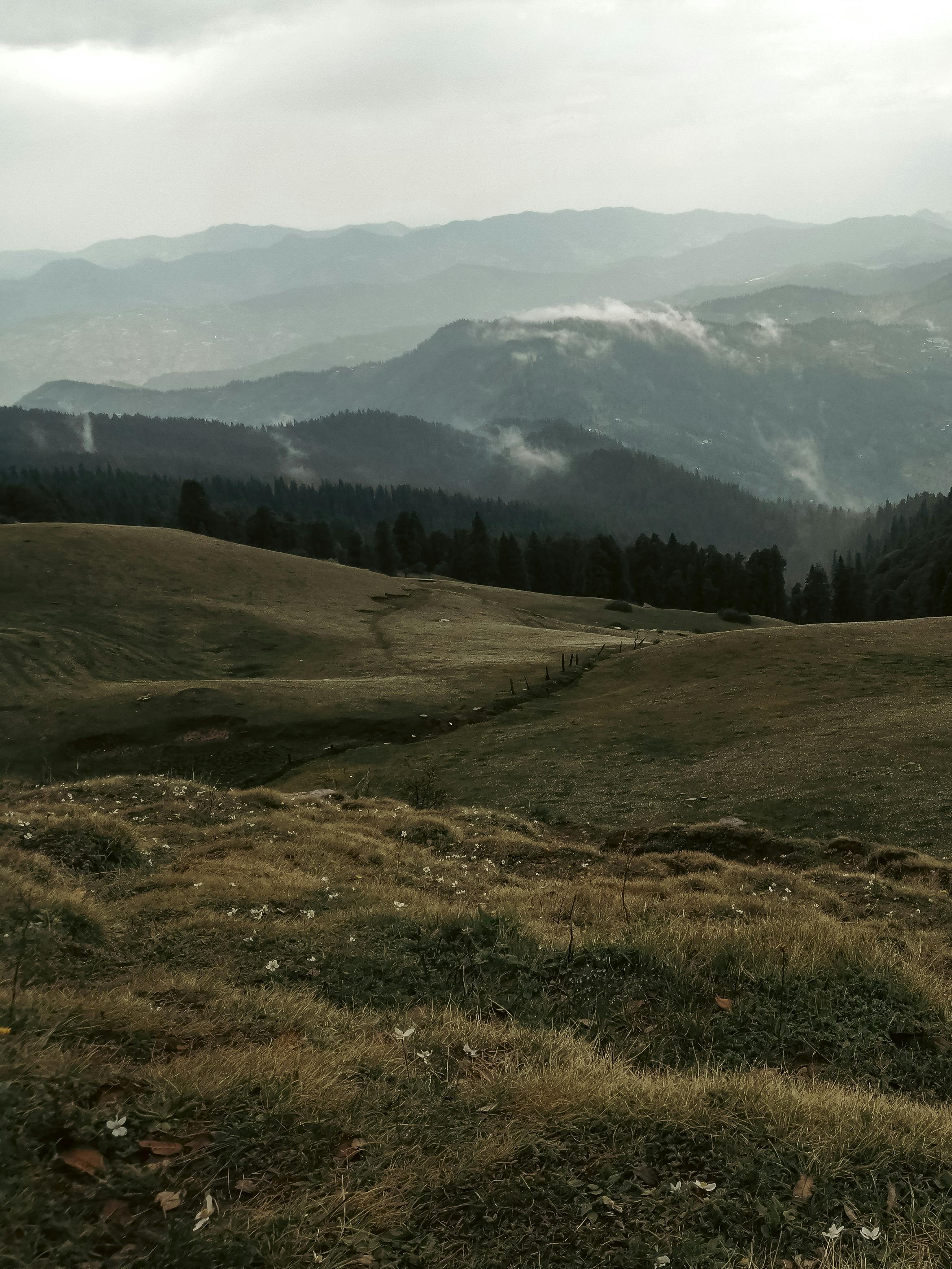 Discover the tranquil beauty of Khumjung's lush hills and misty mountains in Nepal's countryside.