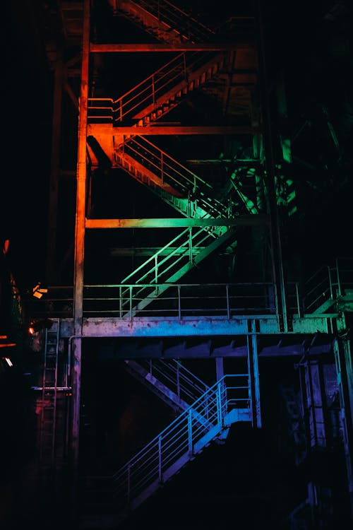 Metal Staircase in Colorful Lights in the Dark