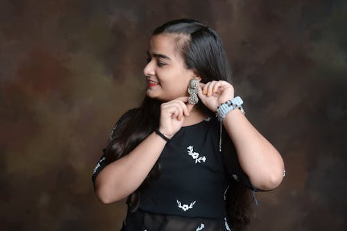 Smiling Woman in Black Dress and with Earring