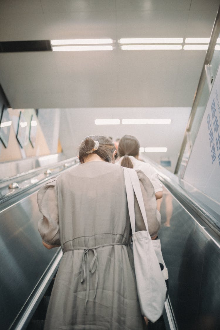 Women On Escalator