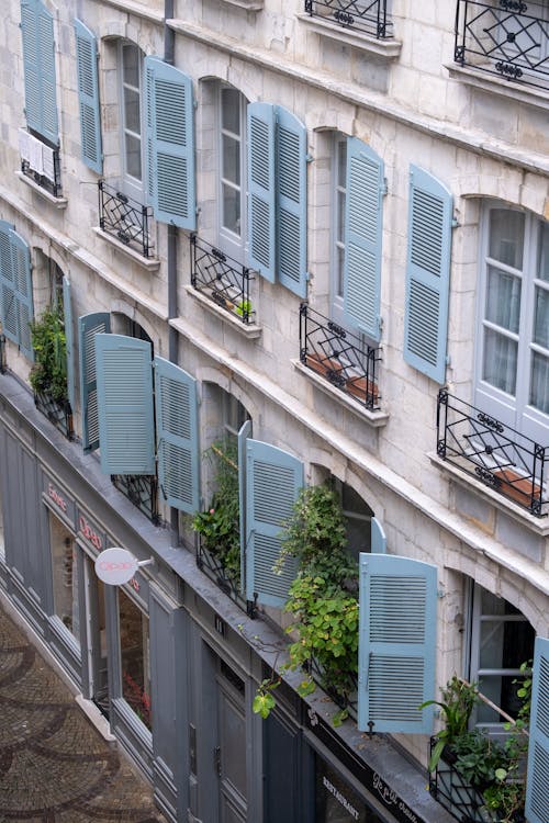 Building Facade with French Balconies and Shutters