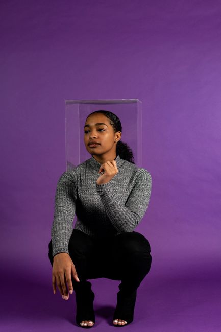 Fashionable woman in a studio setting, showcasing style and elegance.