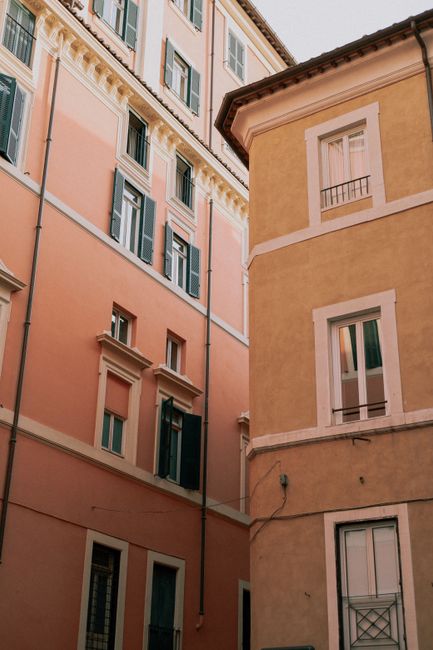Beautiful Italian residential buildings with pastel facades and classic windows.